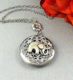 This graceful art deco necklace is 30 inches long. Good Luck Elephant locket is adorned with antique silver finished floral wreath and embellished with baby elephant. I have attached the pendant to antique silver finished floral rosary connector. Necklace is finished with silver chain and silver lobster clasp. Locket is 32mm in size, opens sideways, and has room for two photos! Please note: I DO NOT DO ENGRAVING OR INSERT PICTURES! Thanks for looking:) ~Mani Locket Necklace Silver, Locket Jewelry, Baby Elefant, Silver Locket Necklace, Elephant Jewelry, Lucky Elephant, Wedding Day Jewelry, Round Locket, Silver Locket