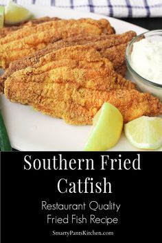 fish fillets on a white plate with lemon wedges and sour cream in the background