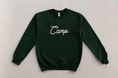 Our Embroidered Camping Sweatshirt is the perfect gift for the outdoor lover in your life!  This vintage style sweatshirt is perfect for your next hiking or camping trip. It features beautiful embroidery that is sure to catch the eye of any nature lover.  We use high-quality thread and state-of-the-art embroidery machines to ensure that these sweatshirts are made with the highest quality materials. They are both comfortable and durable. Show your love for the great outdoors with this unique and Happy Camper Sweatshirt, Summer Camp Merch, Vintage Summer Camp Aesthetic, Vintage Sports Decor, Camping Sweatshirt, Babies Room, Autumn Wardrobe, Nature Shirts, Style Sweatshirt