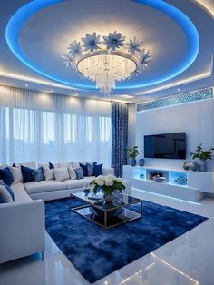 a living room with white furniture and blue accents on the ceiling is lit by recessed lights