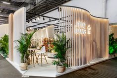 an exhibit booth with plants and chairs