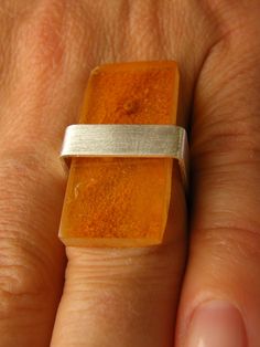 Beautiful ring from Baltic amber, square shape, polished, modern, connected with polished silver 925.  Size of the amber:  30 mm x 13 mm (approx.) Colour:   orange, honey Beautiful unique amber ring. This silver sterling ring with natural amber is out of time, it is perfect for any occasion. All listed items are custom-made jewellery and unique pieces. Nice detail to any outfit. The picture shows in example ring.  The ring arrives in a gift box Sending  as a gift  with airmail and tracking numbe Amber Ring, Natural Amber, Amber Necklace, Amber Stone, Amber Jewelry, Platinum Ring, Baltic Amber, Sterling Ring, Rings Statement