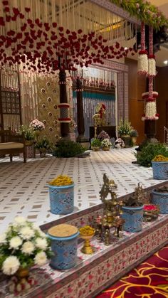 an elaborately decorated hall with flowers and decorations