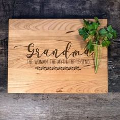 a wooden cutting board with the words grandma on it