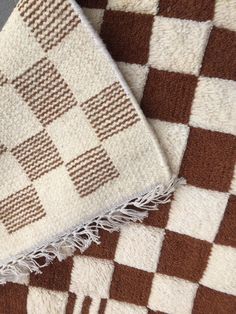 two brown and white rugs sitting next to each other