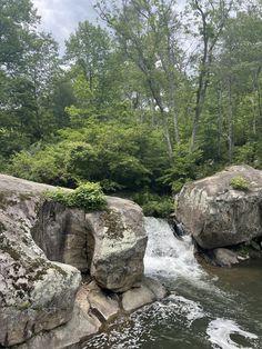 the water is flowing between two large rocks