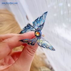 **Unveil the Magic Introducing our Enchanted Butterfly Hair Pin, a whimsical creation by Elven Rose that captures the delicate beauty of a butterfly in mid-flight. This enchanting accessory features sparkling blue AB resin wings paired with a dazzling Blue AB Swarovski crystal body, radiating ethereal elegance and charm. **Key Features - Handcrafted Excellence: Made with love and care, ensuring each piece is unique and of the highest quality. - Mesmerizing Blue AB Resin Wings: The wings shimmer Blue Fairy Jewelry For Party, Blue Fairy-style Jewelry For Party, Butterfly-shaped Crystal Jewelry For Gifts, Blue Crystal Butterfly Necklace, Unique Blue Butterfly-shaped Jewelry, Elven Jewelry, Butterfly Hair, Fairy Tale Wedding, Woodland Wedding