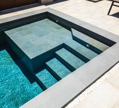 an empty swimming pool in the middle of a patio