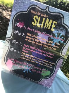 a sign that says how to make slime on the side of a blue table