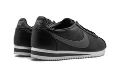 The Nike Classic Cortez Leather is a casual sneaker elevated with premium materials.  The predominantly black shoe maintains the classic Cortez look, which is accented with a tonal fat belly Swoosh and Nike branding.  The Nike Classic Cortez Leather comes complete with a grooved grey outsole.  This modern colorway of one of the original Nike running sneakers is like wearing history on your feet. Nike Cortez Black, Nike Classic Cortez Leather, Classic Cortez, Nike Classic Cortez, Nike Running, Nike Cortez, Running Sneakers, Casual Sneakers, Leather Shoes