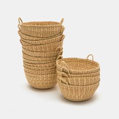 several woven baskets stacked on top of each other