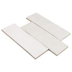 three pieces of white foam sitting next to each other on top of a white surface