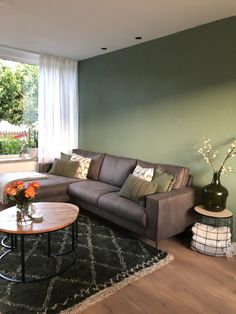 a living room filled with furniture next to a window