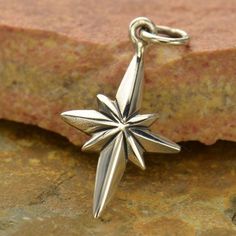 Crafted in solid .925 sterling silver Dimensions: * 22mm high (including jump ring) * 11mm wide * 2mm high/deep Sterling Silver North Star Charm. The brightest shining star in the sky, the North Star, or Polaris, has been leading many for centuries. In Greek mythology, the north star was said to have powers that could control the gods. The Egyptians built pyramids to point to this northernmost star. Polaris has always been helpful to sailors in determining latitude and locating the direction of Shining Star In The Sky, North Star Pendant, Star In The Sky, North Star Necklace, The North Star, Star Charm Necklace, Sparkling Stars, Bird Charm, Celestial Jewelry