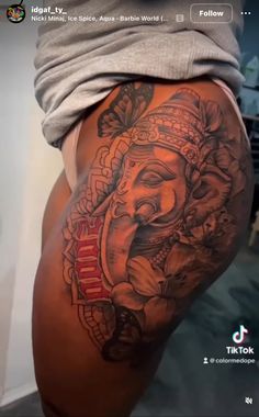 an elephant tattoo on the side of a woman's thigh