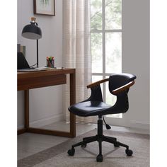 a black office chair sitting in front of a window