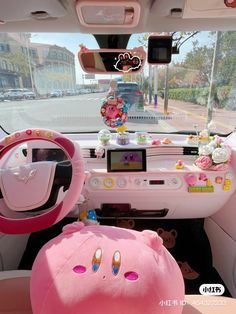 the interior of a car decorated in pink and white with hello kitty decorations on it