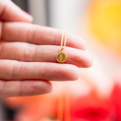 a person is holding a tiny gold necklace Gold Rose Flower, Coin Pendant Necklace, Stunning Necklace, Coin Pendant, Gold Rose, Gold Plating, Rose Flower, Timeless Pieces, Gold Plate