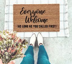 a person standing in front of a door mat that says, the smith family eventually just waiting on the ring