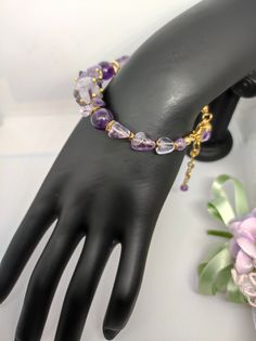 Beautiful modern style bracelet. The bracelet is made with natural amethyst beads of different shapes. The bracelet has a gold-plated stainless steel lobster clasp closure. The bracelet is 19 cm long, adjustable clasp with 5 cm extension. The bracelet is slightly stiff and looks great on the wrist. The bracelet is very particular, but at the same time it is very elegant, made with various shapes of natural stones separated by gold-plated metal elements. For those who love handmade jewellery. All jewels are delivered in a decorated box, ready to be given as a gift to your loved one. How to take care of your jewellery: put on your beauty products (cosmetics, perfumes, ...) before wearing your precious jewel. Clean your jewelry with a soft cloth after wearing. Don't use water. Make sure you s Modern Bracelet, Bracelet Elegant, Modern Bracelets, Amethyst Stones, Precious Jewels, Elegant Bracelet, Amethyst Bracelet, Amethyst Beads, Amethyst Purple