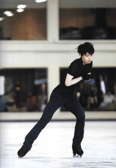 a young man skating on an ice rink