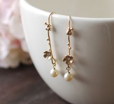 Twig Earrings Matte Gold Twig with Lady Bug Cubic by LeChaim, $22.00 Delicate Gold Teardrop Flower Earrings, Dainty Pearl Drop Flower Earrings, Delicate Rose Gold Flower Earrings, Gold Dangle Flower Earrings With Hooks, Gold Nature-inspired Flower Earrings, Gold Botanical Dangle Earrings, Gold Botanical Flower Earrings, Nature-inspired Gold Flower Earrings With Charm, Twig Earrings