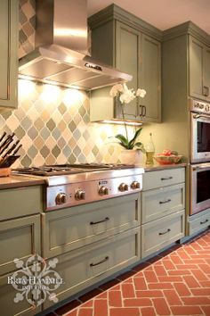 an image of a kitchen setting with stainless steel appliances and tile backsplashes