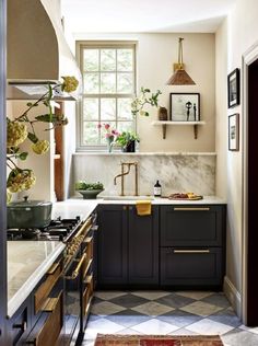 a kitchen with marble counter tops and black cabinets, along with an open window to the outside