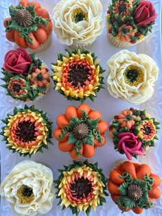 cupcakes decorated with flowers and leaves on a plate