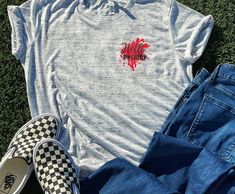 a t - shirt with the words walking dead on it next to jeans and slippers