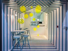 the interior of a restaurant with yellow and white decorations