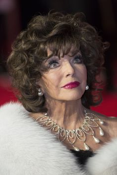 an older woman wearing a fur coat and pearls