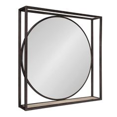 a round mirror sitting on top of a metal frame