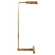 a brass floor lamp with a white background