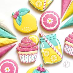 decorated cookies are arranged in the shape of lemonades, cupcakes and candy