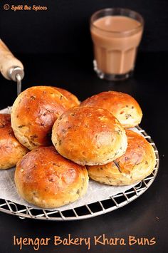 several rolls on a plate with a glass of chocolate milk in the background