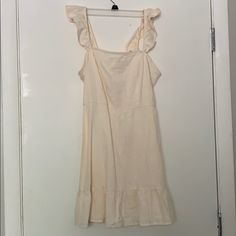 This Is A Super Cute Cream Linen Dress. It Has A Ruffle Style Sleeve And Bottom Detail. Zipper On The Back Cream Ruffled Sundress For The Beach, Cotton Ruffle Dress For Brunch, Cream Ruffle Dress With Ruffle Hem For Spring, Cream Ruffled Sundress For Vacation, White Ruffle Sleeve Mini Dress For Daywear, White Sleeveless Casual Ruffle Dress, White Mini Dress With Ruffle Sleeves For Daywear, Summer Cream Ruffle Dress, Casual Mini Dress With Ruffled Straps For Brunch