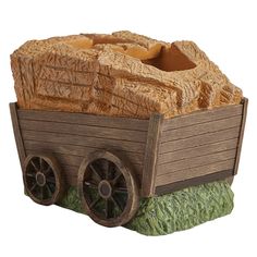 a wooden wagon with wheels is shown on a white background and has grass in the foreground