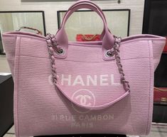 CHANEL Deauville Tote Pink color with white letters  Silver Hardware  Can be used 2 ways, with handles and straps  CHANEL Rue Cambon PARIS on front of the handbag  great bag for traveling  Comes with a detachable zippered pouch that can be used as a wallet or pouch  11.7 × 19.5 × 8.6 in New with tags, box, authenticity card, ribbon, etc   (everything i received from chanel store)  Can show receipt for authenticity. Chanel Tote Bag 2022, Pink Wallpaper Shopping Bag, Luxury Purses Chanel, Vintage Chanel Tote Bag, Chanel Pink Bag, Chanel Shopper, Pink Chanel Bag, Leather Work Bag, Chanel Tote Bag