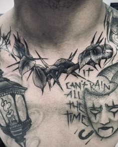 a man with tattoos on his chest has an image of two birds and a lantern