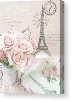 pink roses are in a vase next to an envelope with the eiffel tower on it