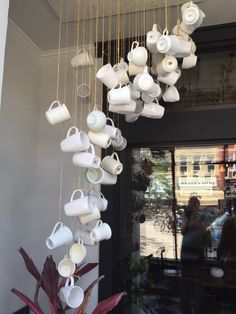 coffee cups and saucers hanging from the ceiling