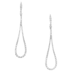 Elegant Loop shaped dangle diamond earrings. Comprised of 16 single cut diamonds totaling .90cts, set in 14k white gold loop style settings. 1.8 inches long diamond dangle drop earrings. Follow us on our 1stDibs storefront to view our weekly new additions and 5 Star Reviews at Peter Suchy Jewelers. 16 single cut diamonds, G-H SI approx. .90cts 14k white gold Stamped: 14k 3.6 grams Top to bottom: 46.0mm or 1.8 inch Width: 10.5mm or .41 Inches Depth or thickness: 1.9mm Luxury White Gold Long Drop Linear Earrings, Formal Teardrop Single Cut Diamond Earrings, Formal Pear-shaped Diamond Earrings With Single Cut Diamonds, Teardrop Platinum Diamond Earrings With Prong Setting, Platinum Teardrop Diamond Earrings With Brilliant Cut, Platinum Pear-shaped Diamond Earrings With Accents, Drop Diamond Earrings With Pave Setting, Drop Diamond Earrings With Pave Setting For Formal Events, Pear-shaped Diamond White Diamond Earrings For Evening