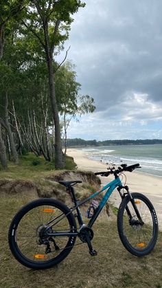 a bike parked on the side of a beach