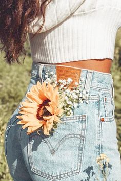 a woman with a sunflower in her pocket