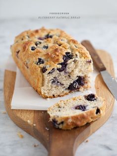 a loaf of blueberry bread sitting on top of a cutting board