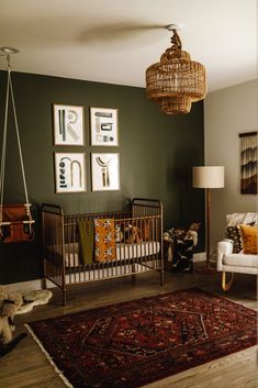 a baby's room with green walls and pictures on the wall, including a crib