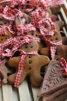 gingerbread cookies with red and white ribbon tied around them