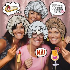 three women are posing for a photo booth