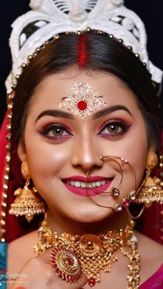 a woman with makeup and jewelry on her face